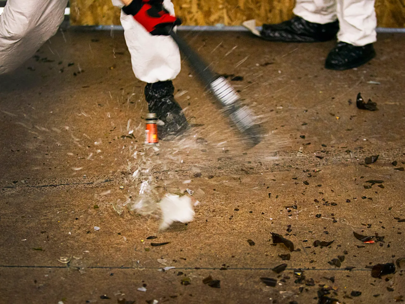 A bottle is smashed with a baseball bat at Wreck Room