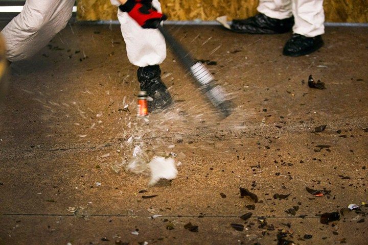 A bottle is smashed with a baseball bat at Wreck Room