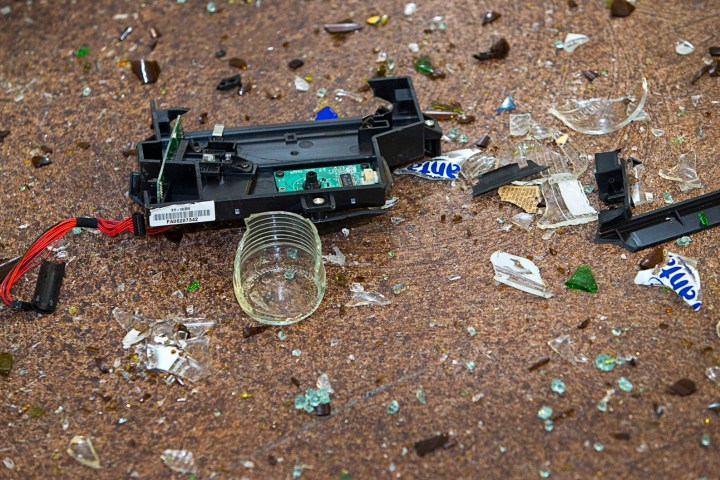 The floor is scattered with broken glass and printer parts after a session at Wreck Room